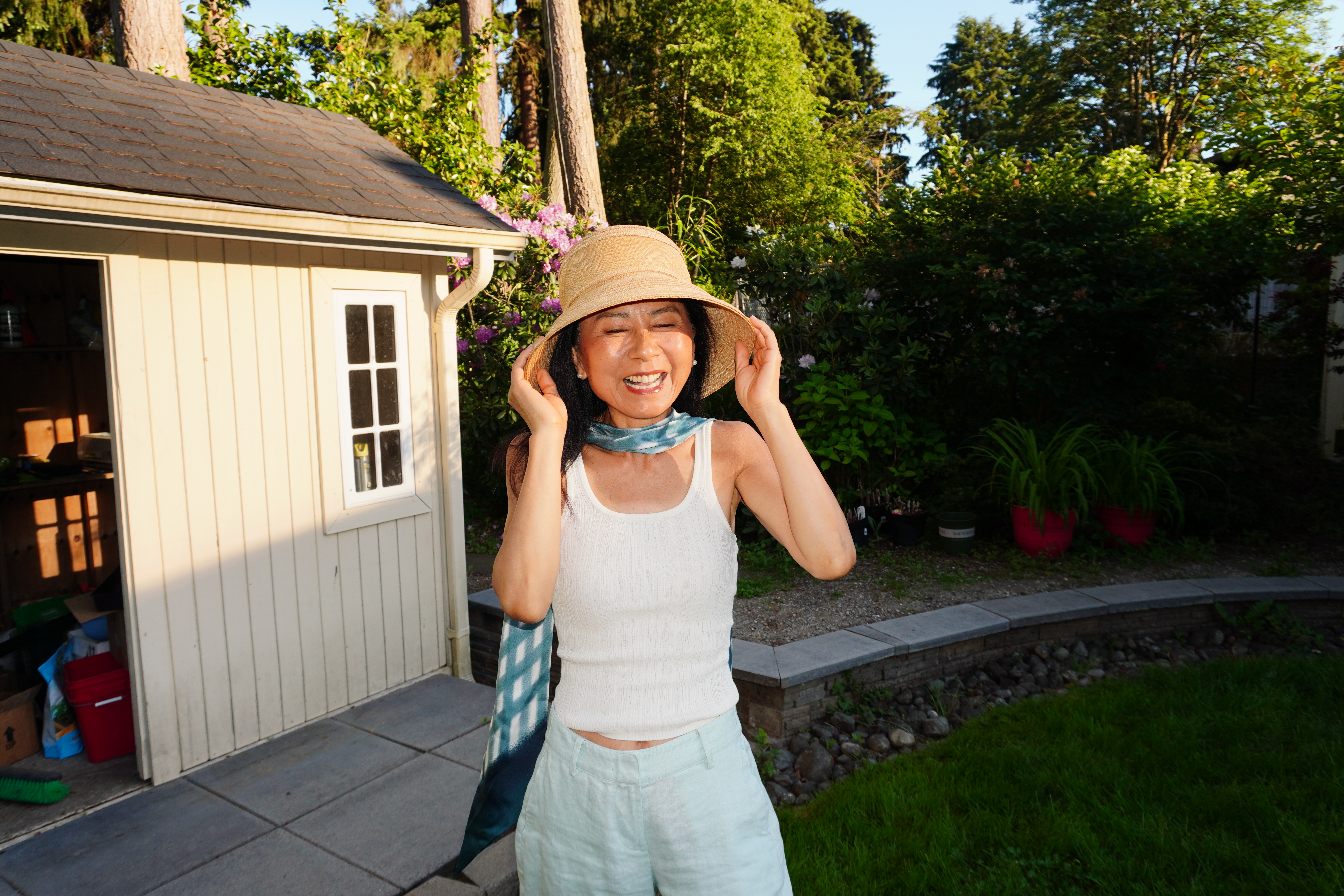 Janney laughing outside the garden shed where the tools live